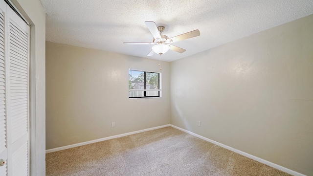 90 Wellshire Ln, Palm Coast, FL 32164 - unfurnished bedroom with ceiling fan, a textured ceiling, baseboards, a closet, and carpet