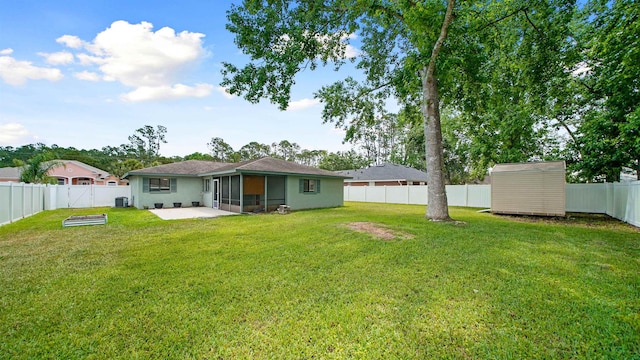 90 Wellshire Ln, Palm Coast, FL 32164 - back of property with a sunroom, a fenced backyard, an outbuilding, a patio area, and a lawn