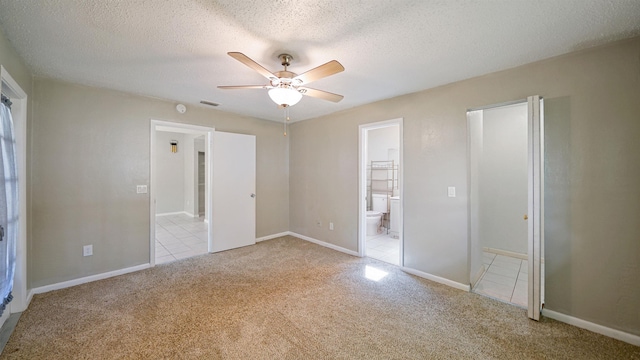 90 Wellshire Ln, Palm Coast, FL 32164 - unfurnished bedroom featuring visible vents, light carpet, a textured ceiling, and connected bathroom