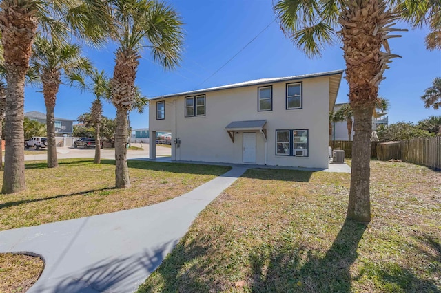 view of front of house with a front lawn and central air condition unit