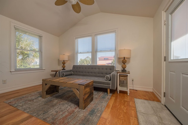 living room featuring light wood-type flooring, plenty of natural light, ceiling fan, and vaulted ceiling