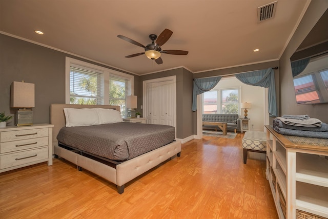 bedroom featuring ornamental molding, a closet, and light wood-type flooring