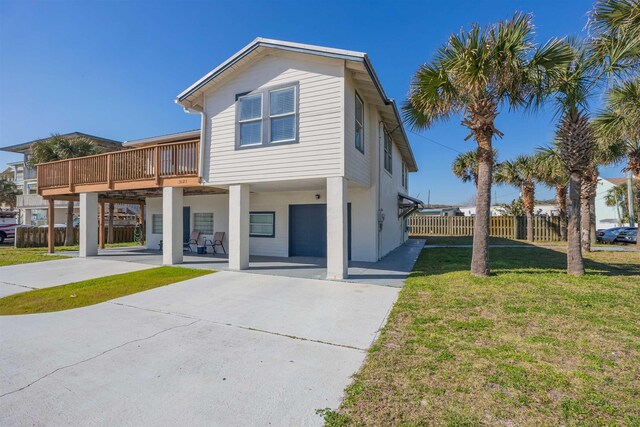 view of front of house featuring a garage, a deck, and a front lawn