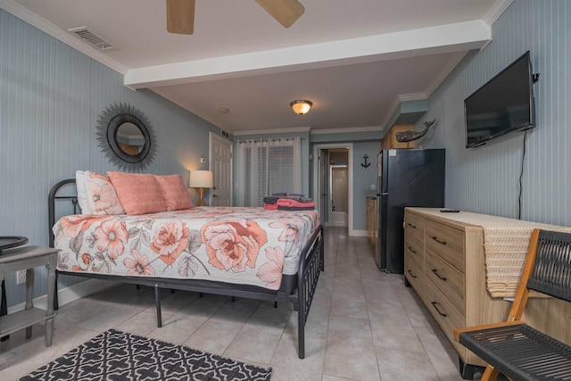 bedroom with light tile patterned flooring, ceiling fan, crown molding, black fridge, and beam ceiling