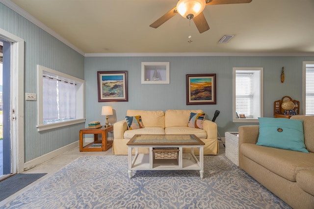 tiled living room featuring ceiling fan and ornamental molding