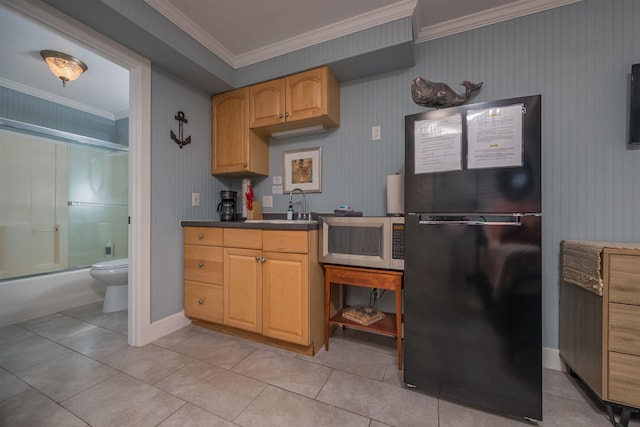 kitchen with sink, crown molding, light tile patterned floors, black fridge, and light brown cabinets