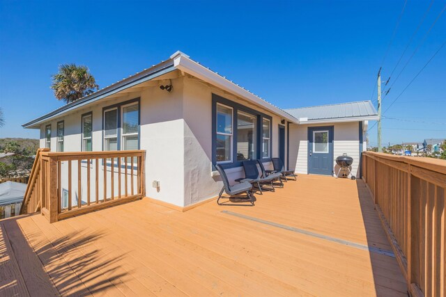 wooden deck with a grill