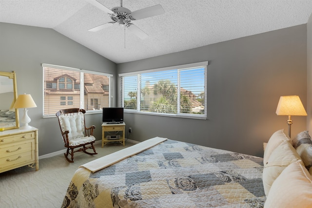 bedroom with a ceiling fan, carpet flooring, vaulted ceiling, a textured ceiling, and baseboards