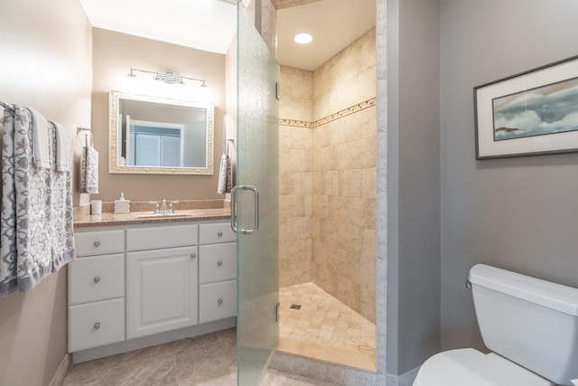 bathroom featuring a stall shower, vanity, and toilet