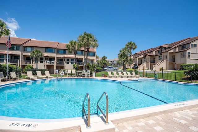 pool featuring fence and a residential view