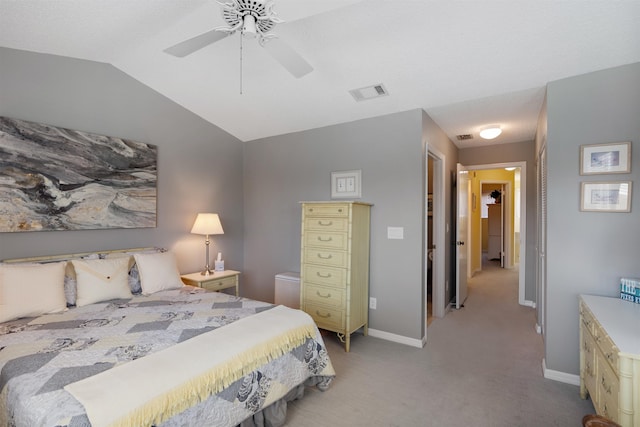 bedroom with light colored carpet, vaulted ceiling, visible vents, and baseboards