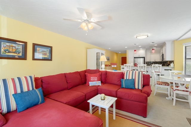 living room featuring ceiling fan, recessed lighting, and light colored carpet