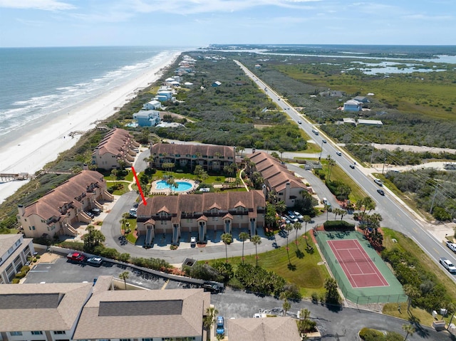 drone / aerial view with a beach view and a water view