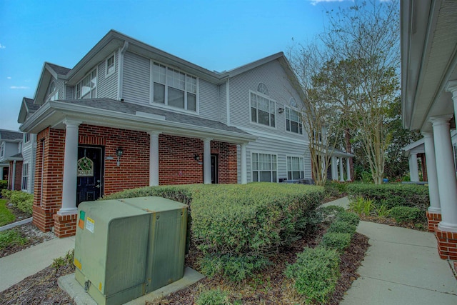 view of side of home featuring brick siding