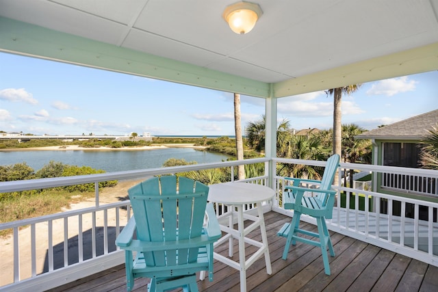 wooden deck featuring a water view