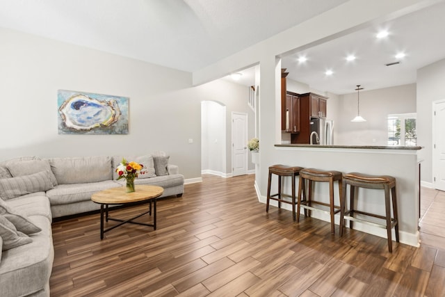 153 Savanna Preserve Ct, Saint Augustine, FL 32095 - living area with arched walkways, wood finished floors, baseboards, and recessed lighting