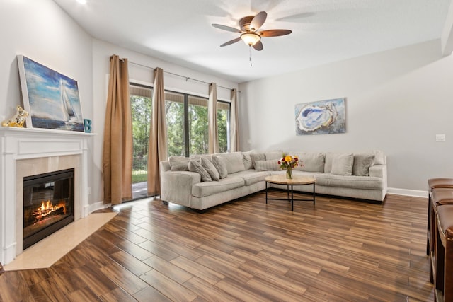 153 Savanna Preserve Ct, Saint Augustine, FL 32095 - living room featuring a ceiling fan, a premium fireplace, dark wood-style floors, and baseboards