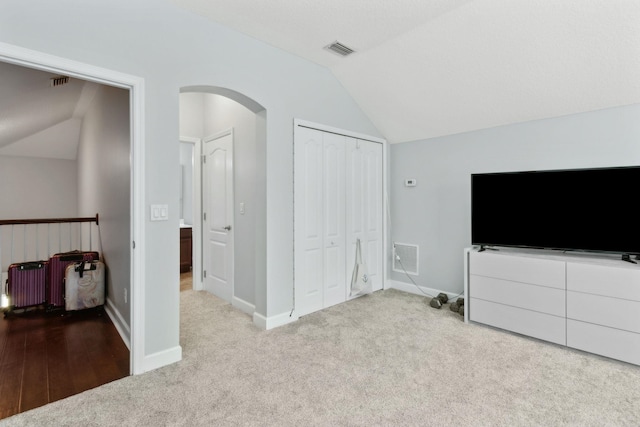 153 Savanna Preserve Ct, Saint Augustine, FL 32095 - unfurnished bedroom featuring vaulted ceiling, carpet floors, a closet, arched walkways, and baseboards