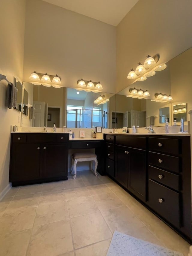 bathroom with vanity, an enclosed shower, tile patterned flooring, and a high ceiling