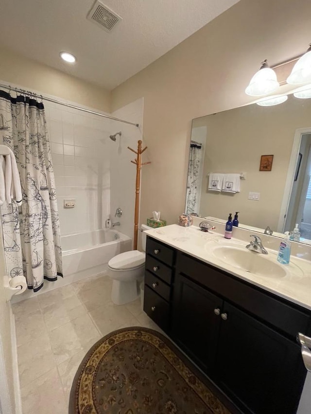 full bathroom featuring tile patterned floors, vanity, toilet, and shower / tub combo