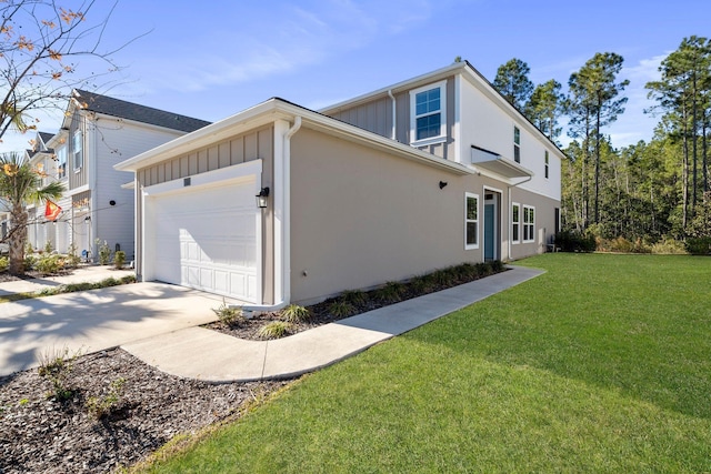 view of side of property with a garage and a yard