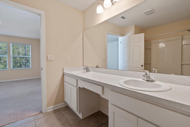 bathroom with tile patterned flooring and vanity