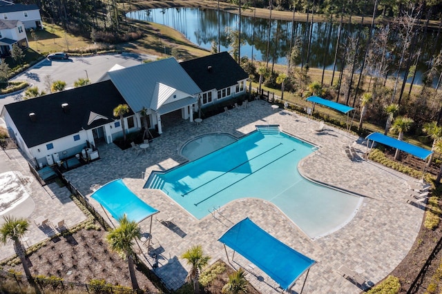 view of pool with a patio area and a water view