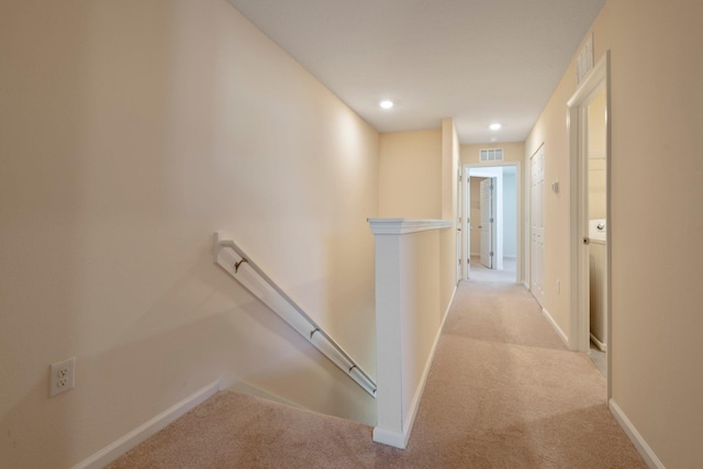 hallway with light colored carpet