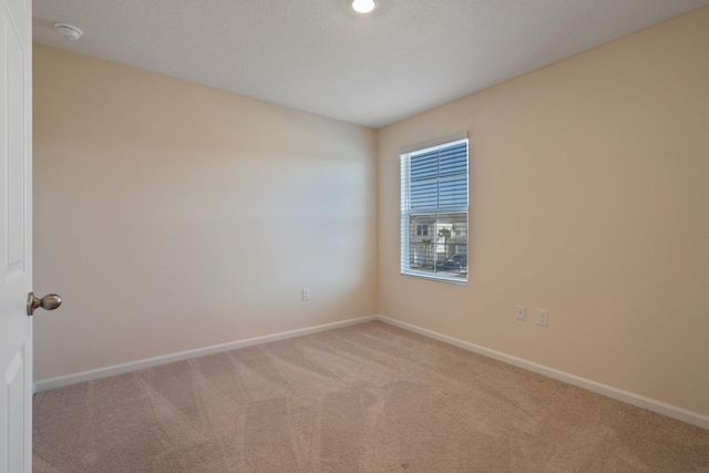 empty room featuring light colored carpet