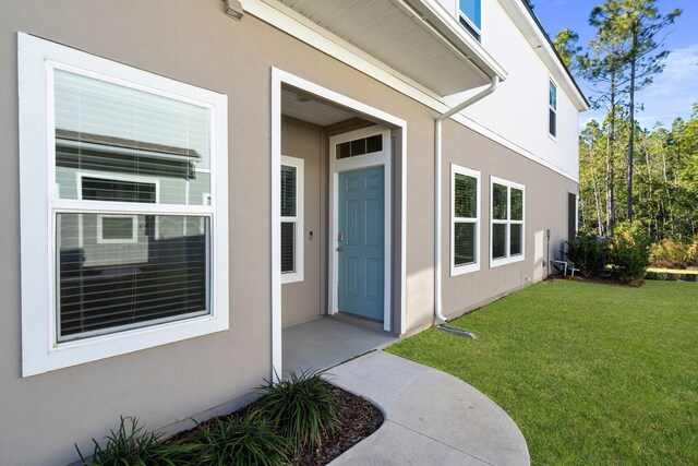 property entrance with a yard