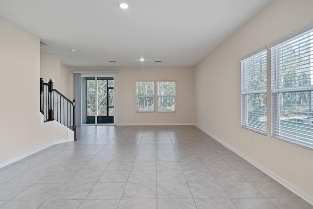 unfurnished room featuring light tile patterned floors