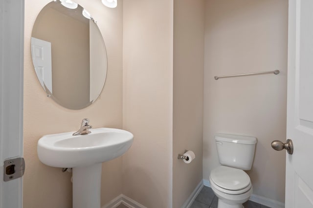 bathroom featuring toilet and tile patterned floors