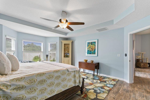 132 Fallen Timber Way, Saint Augustine, FL 32084 - bedroom featuring wood finished floors, a tray ceiling, and a ceiling fan