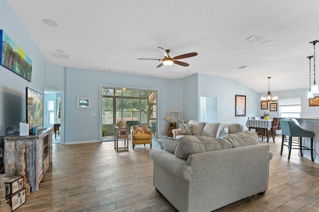 132 Fallen Timber Way, Saint Augustine, FL 32084 - living room with hardwood / wood-style floors, ceiling fan, a chandelier, lofted ceiling, and a textured ceiling