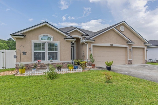 132 Fallen Timber Way, Saint Augustine, FL 32084 - ranch-style house featuring stucco siding, driveway, an attached garage, and stone siding