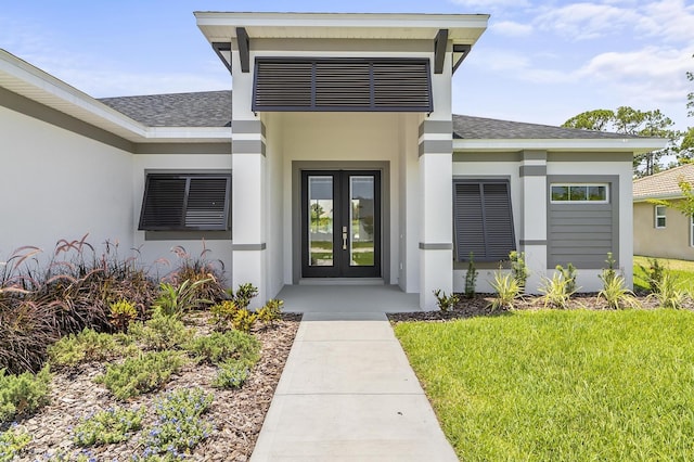 1 Clementon Ln, Palm Coast, FL 32137 - view of exterior entry with roof with shingles, french doors, and stucco siding