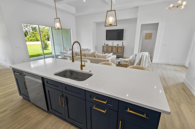1 Clementon Ln, Palm Coast, FL 32137 - kitchen featuring stainless steel dishwasher, open floor plan, light wood finished floors, light countertops, and hanging light fixtures