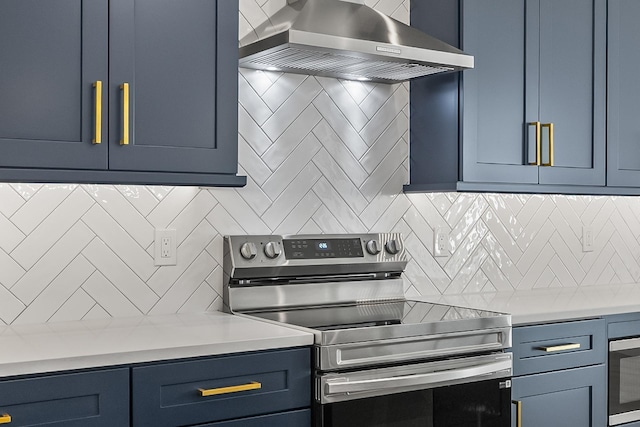 1 Clementon Ln, Palm Coast, FL 32137 - kitchen featuring stainless steel electric range oven, wall chimney exhaust hood, blue cabinets, decorative backsplash, and light countertops