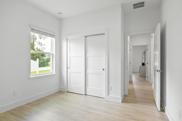 1 Clementon Ln, Palm Coast, FL 32137 - unfurnished bedroom featuring light wood-style floors and a closet