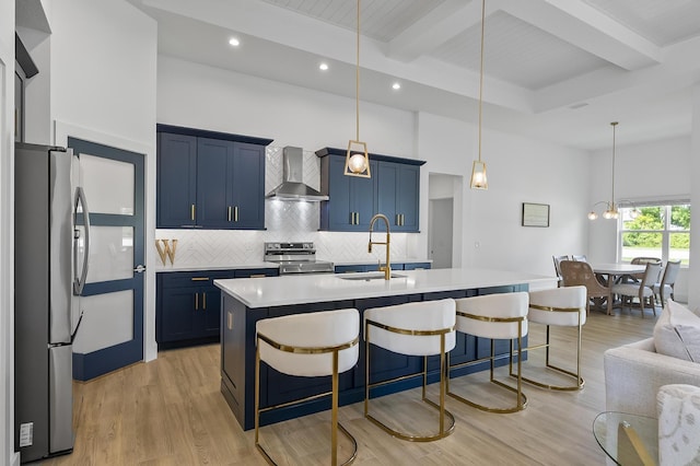 1 Clementon Ln, Palm Coast, FL 32137 - kitchen featuring appliances with stainless steel finishes, wall chimney exhaust hood, blue cabinetry, a breakfast bar, and beamed ceiling