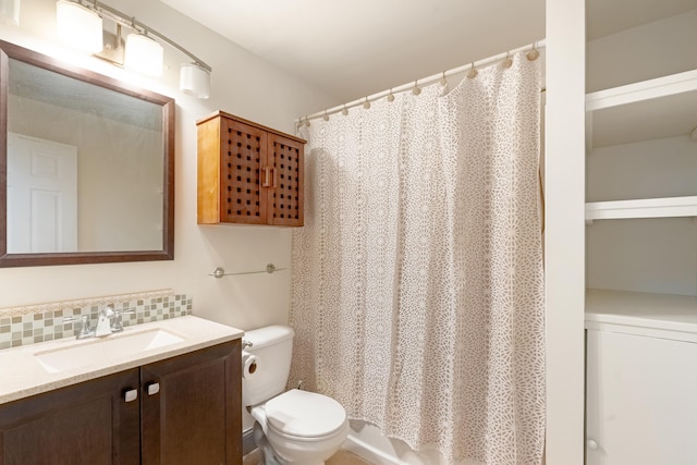 bathroom with decorative backsplash, vanity, and toilet