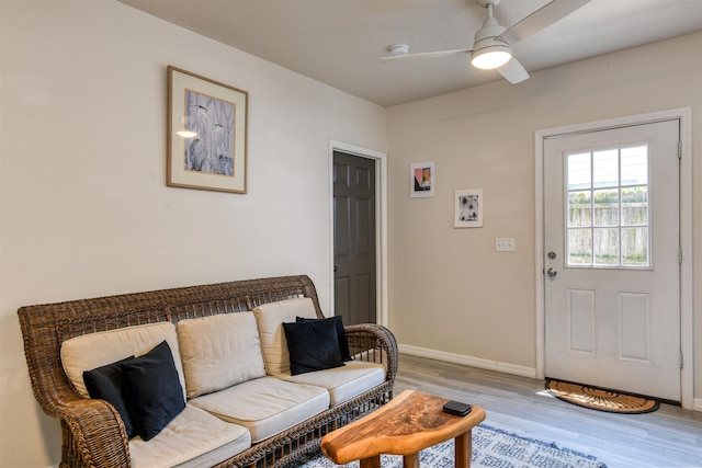 living room with ceiling fan and light hardwood / wood-style floors