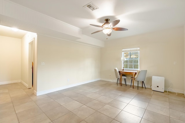 tiled empty room with ceiling fan