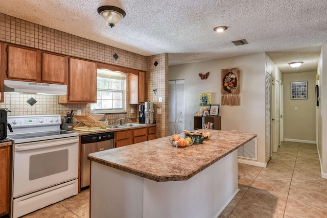 kitchen with stainless steel dishwasher, sink, light tile patterned floors, electric range, and a center island