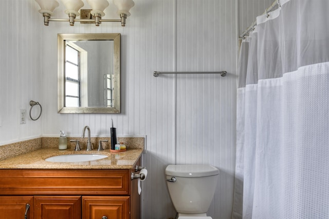 bathroom featuring a shower with curtain, vanity, and toilet