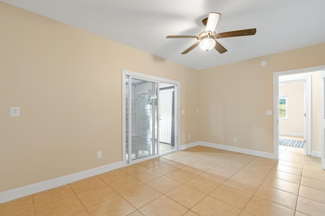 tiled empty room with plenty of natural light and ceiling fan