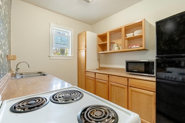 kitchen featuring sink, stove, and light brown cabinets