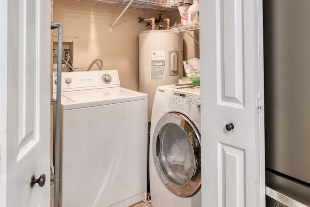 washroom with washing machine and dryer and electric water heater