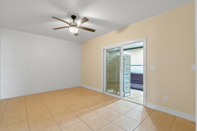 tiled spare room featuring ceiling fan