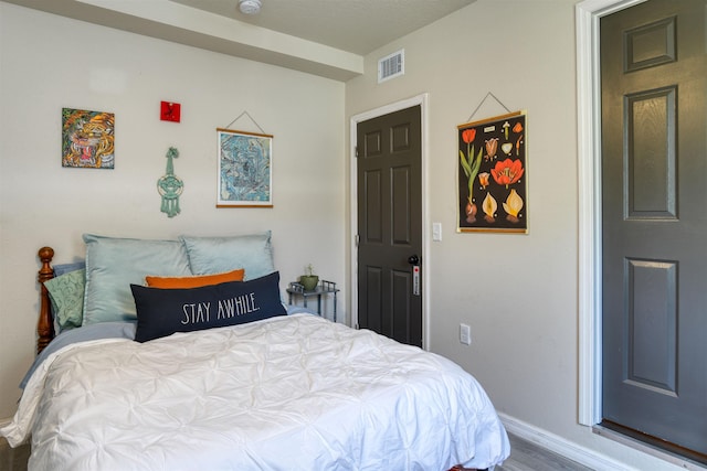 bedroom with wood-type flooring